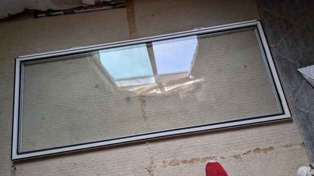 Replacement window staged before installation.