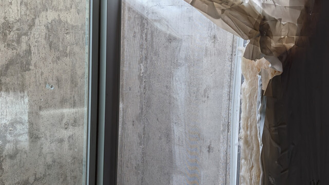 Interior view of the basement window and surrounding opening during the repair.