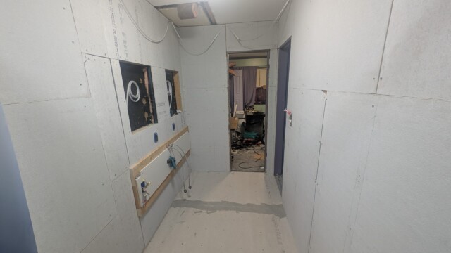 Bathroom walls and fixtures during the early remodel.