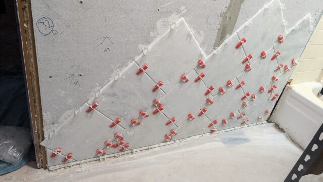 Shower wall board with seams prepared for tile.