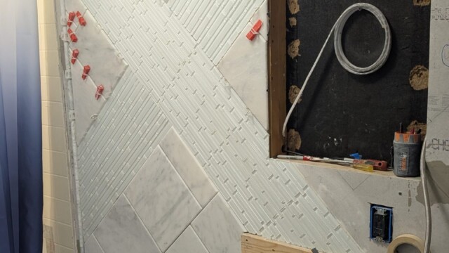Shower plumbing and wall surfaces before tile installation.