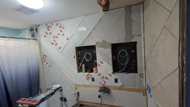 Shower plumbing and wall openings during construction.