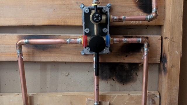 Shower plumbing exposed during the remodel.