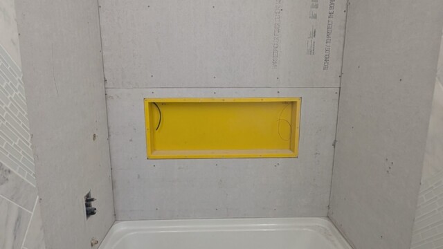 Shower niche framed into the wall.