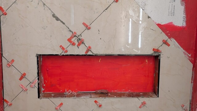 Waterproofed shower wall and niche before tiling.