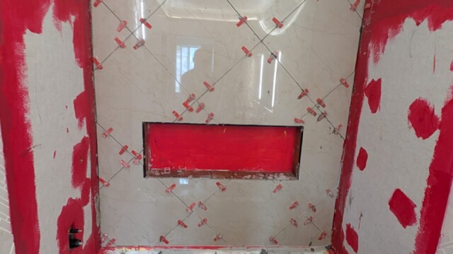 Shower walls covered with waterproofing around the niche.