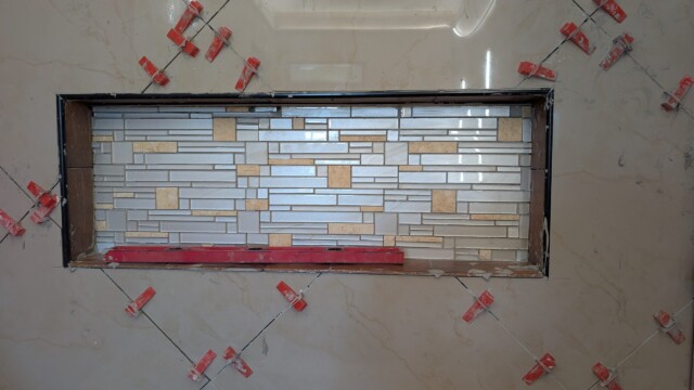 Waterproofing applied around the shower niche.
