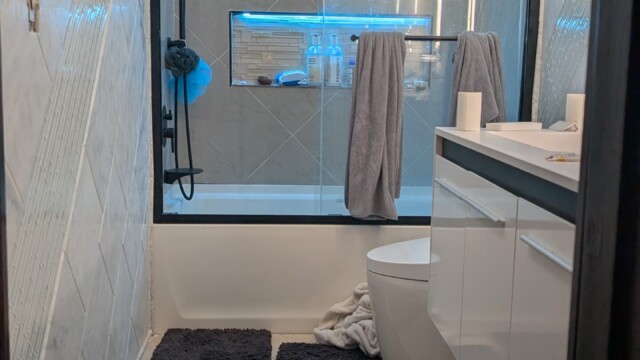 Finished bathroom with a glass shower enclosure and vanity.